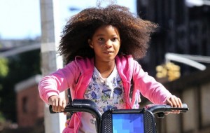 Quvenzhane Wallis rides a public bike while shooting the remake of 'Annie', on location in Harlem, NY