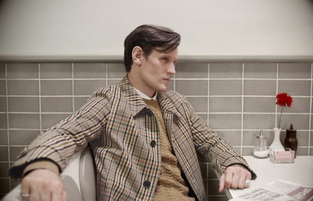 Matt Smith wears a check car coat with a cashmere cable-knit sweater c Courtesy of Burberry